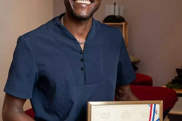 Dominique tenant son diplôme de Meilleur Spa Praticien de France
